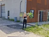 Guna walking with a plant in her hands